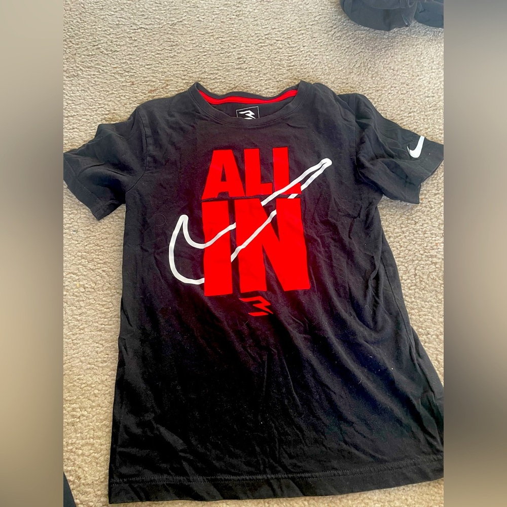 Brand new. Never worn.
Nike Black Tee with Red 'All In' Graphic